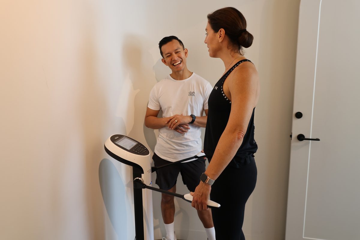 A Club Crux coach talking a member through her InBody scan results.